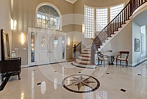 Stunning two story entry foyer with marble mosaic tiled floor