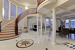 Stunning two story entry foyer with marble mosaic tiled floor