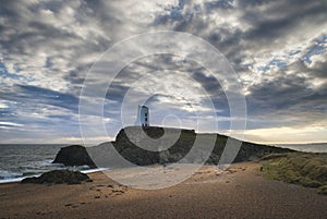 Stunning Twr Mawr lighthouse landscape from beach with dramatic
