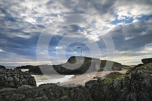 Stunning Twr Mawr lighthouse landscape from beach with dramatic