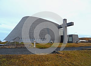 Stunning unique church with a big cross against the morning sky