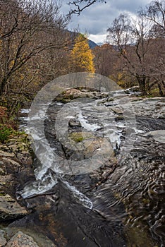 Stunning vibrant landscape image of Aira Force Upper Falls in Lake District during colorful Autumn showing