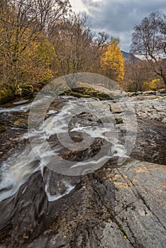 Stunning vibrant landscape image of Aira Force Upper Falls in Lake District during colorful Autumn showing