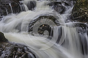 Stunning vibrant landscape image of Aira Force Upper Falls in Lake District during colorful Autumn showing