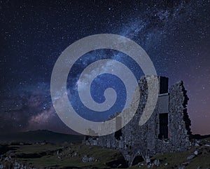 Stunning vibrant Milky Way composite image over abandoned Foggintor Quarry in Dartmoor with raking soft sunlight over ruins and photo