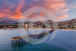 Vibrant sky over Ventura beach with a long pier at sunset, California, USA