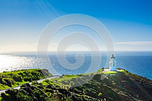 Stunning view of Cape Reinga Lighthouse glowing in sunlight. Famous tourist attraction at Cape Reinga, Far North, New