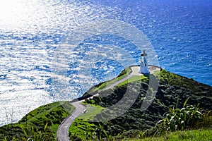 Stunning view at Cape Reinga Lighthouse and a winding path leading to it. Famous tourist attraction at Cape Reinga, Far