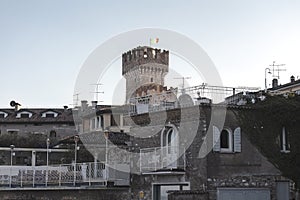 A stunning view of the castle in Sirmione, Italy, surrounded by the beautiful blue waters of Lake Garda. The ancient walls and