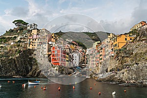 Stunning view of colorful Riomaggiore village at sunset in Cinque Terre, Italy