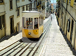 Stunning view of the famous Elevador Da Bica, a retro yellow tram operating in the historic center of Lisbon, Portugal photo