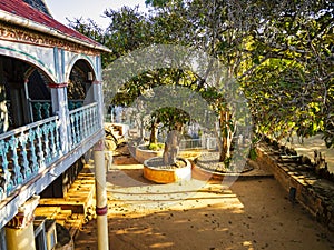 Stunning view of Fandriampahalemana palace and its beautiful courtyard with sacred fig trees, Ambohimanga, Madagascar