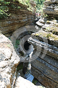 Stunning view from a height of water flowing in a small canzon reminiscent of an accordion