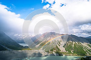 Stunning view on the high mountain after the rain with colorful rainbow over the rocky mountain and glacier in Mt Cook National