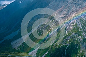 Stunning view on the high mountain after the rain with colorful rainbow over the rocky mountain and glacier in Mt Cook National