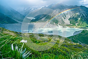 Stunning view on the high mountain after the rain with colorful rainbow over the rocky mountain and glacier in Mt Cook National