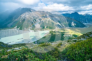 Stunning view on the high mountain after the rain with colorful rainbow over the rocky mountain and glacier in Mt Cook National