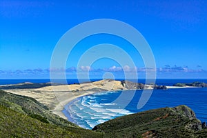 Stunning view from a high vantage point over Te Werahi Beach and Cape Maria Van Diemen in Cape Reinga on a bright winter