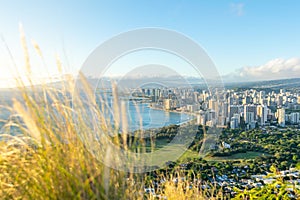 Stunning view of Honolulu and Waikiki Beach seen from the summit of Diamond Head Crater, Oahu, Hawaii. Beautiful evening just befo