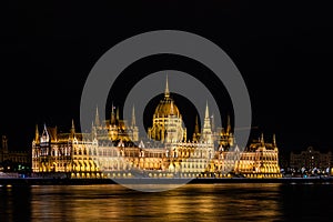 Stunning view of the Hungarian Parliament Building at the bank of River Danube at night in Budapest