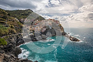 Stunning view of Manarola village in Cinque Terre National Park, beautiful cityscape with colorful houses and green