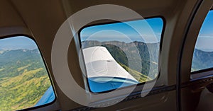 Stunning view of mountain range from a window of a small airplane during take off. Air travel in Fiji, Melanesia, Oceania.