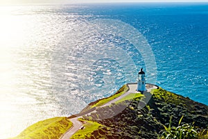 Stunning view over Cape Reinga Lighthouse and a winding path leading to it. Famous tourist attraction at Cape Reinga