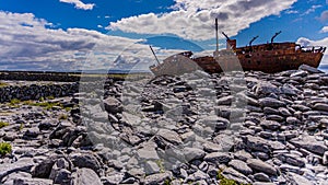 Stunning view of the rocky beach of Inis Oirr Island with the Plassey shipwreck in the background