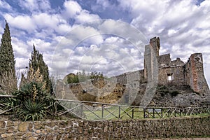 Stunning view of the ruins of the Rocca Aldobrandesca of Sovana, Grosseto, Tuscany, Italy, against a dramatic sky