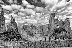 Stunning black and white view of the ruins of the Rocca Aldobrandesca of Sovana, Grosseto, Tuscany, Italy, against a dramatic sky