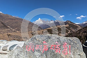 Stunning view of the Siguniang Four Sisters Mountain in Sichuan, China, the words on the stone represents the name of the