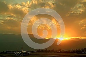 Stunning view of sunrise over the mountain ranges with the airport runway in the foreground