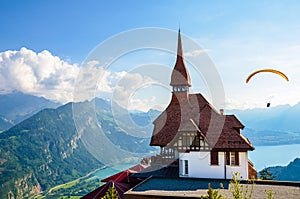 Stunning view of the top of Harder Kulm in Interlaken, Switzerland photographed in summer with paragliders flying around. Hilly photo