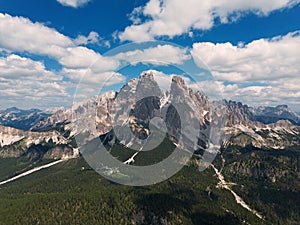 Stunning view of a tourist on the top of a hill enjoying the view of the Cadini di Misurina during sunrise. Cadini di