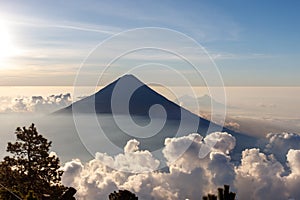 Stunning view of Volcan de Agua from Volcan de Acatenango in Guatemala during morning fog rising. from valley photo