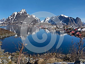 Stunning viewpoint at Reine fishing village, Lofoten Islands, Norway, landscape and seascape of clear water reflection, mountain