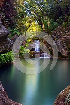Stunning waterfall with an emerald pond in deep green forest in Manavgat, Antalya, Turkey