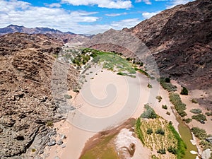 Stunning wide angle aerial drone view of the dry riverbed and mountains near Ai-Ais Hot Springs at the southern end of Fish River