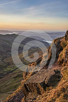 Stunning Winter dawn landscape view from Red Screes in Lake District looking South towards Windermere with colorful vibrant sky