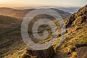 Stunning Winter dawn landscape view from Red Screes in Lake District looking South towards Windermere with colorful vibrant sky