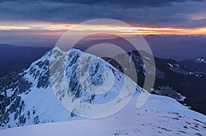 Stunning winter evening mountains landscape and the citylights in the valley, Brasov