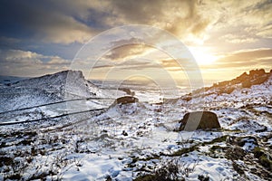 Stunning Winter sunset over countryside landscape with dramatic