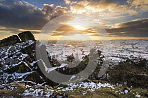 Stunning Winter sunset over countryside landscape with dramatic