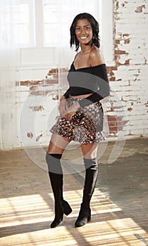 Stunning young African-American woman poses in studio - fashion