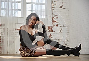 Stunning young African-American woman poses in studio - fashion