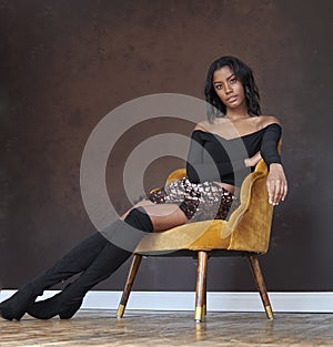 Stunning young African-American woman poses in studio - fashion