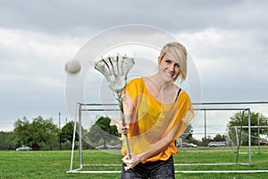 Stunning young blonde female lacrosse player