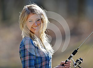 Stunning young blonde woman fishing