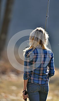 Stunning young blonde woman fishing