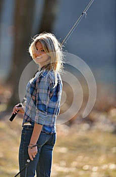 Stunning young blonde woman fishing